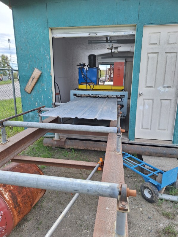 A picture showing the metal press lance chainlink uses to cut the Tuff-rib metal roofing panels in Prince-George.